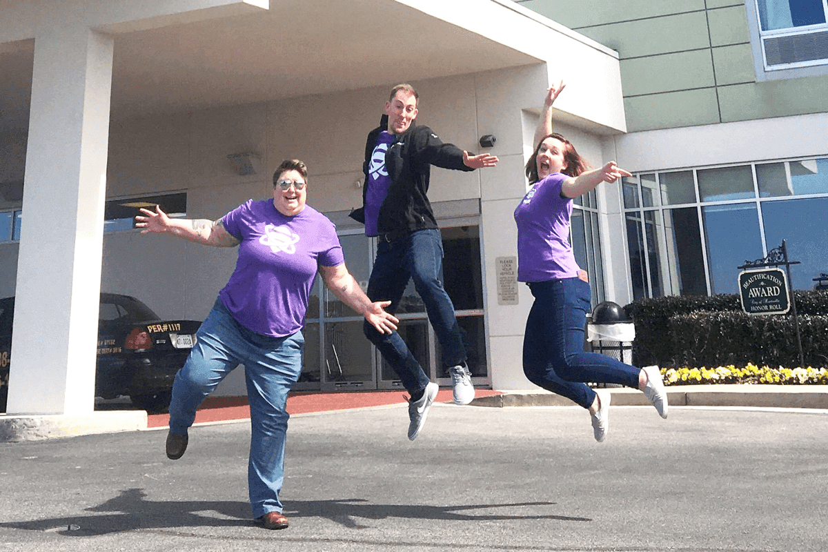 Spur team members jumping with excitement